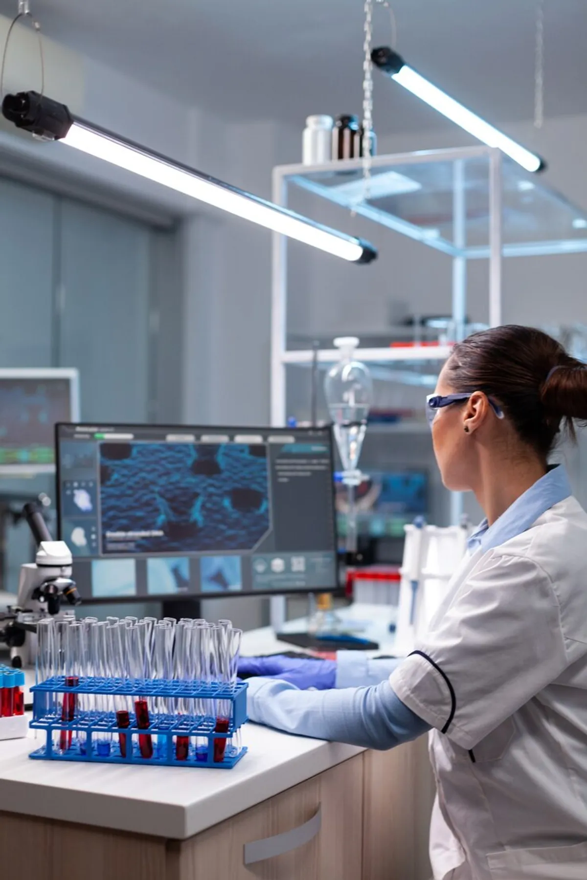 Biochemistry doctor checking microscope.