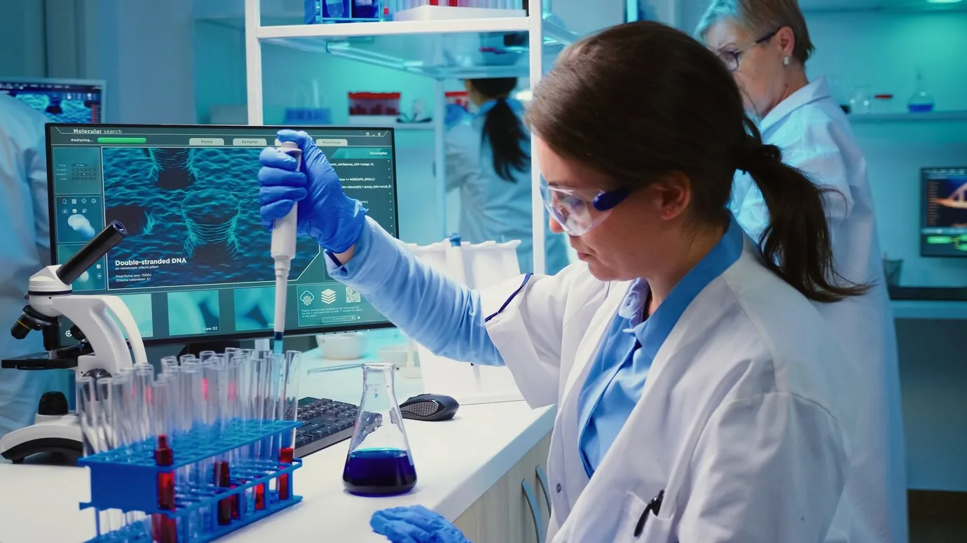 Chemist putting liquid test tube.